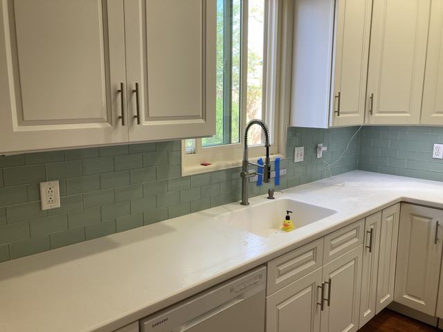 Glass subway tile backsplash